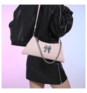 Pink PU leather crossbody bag featuring silver metal bow and chunky chain detail