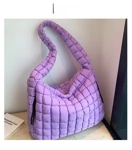 Close-up of purple quilted puffy bag featuring a textured cloud-like nylon fabric