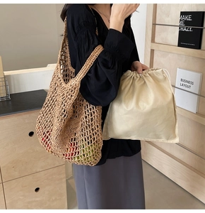 Detail of handmade straw net bag with drawstring inner pouch showing woven texture