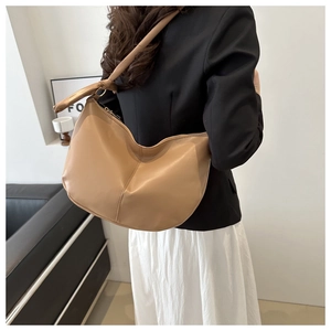 Detail of camel PU leather hobo bag with knotted strap design and metallic zipper
