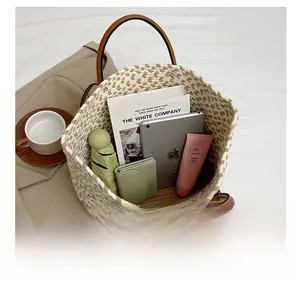 Detail of checkered woven tote bag showing large capacity with daily essentials and tablet