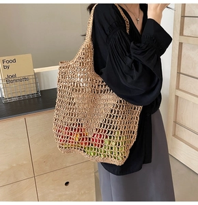 Detail of woven straw tote bag mesh texture showing large capacity with fresh fruits