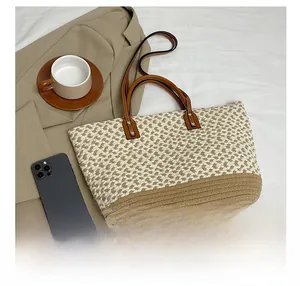 Close-up of bohemian woven tote bag with two-tone texture and brown leather handles