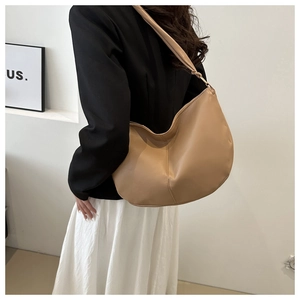 Detailed side view of beige PU leather hobo bag showing large capacity and soft texture
