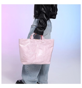 Macro shot of pink DuPont paper tote bag with shiny finish and TOTE BAG lettering print