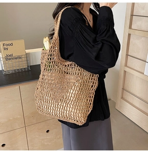 Close-up of handmade hollow straw tote bag featuring detailed large mesh crochet texture