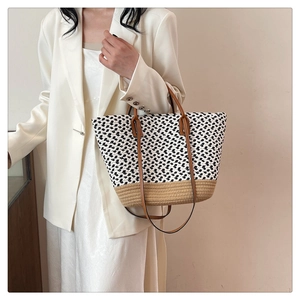 Close-up of bohemian woven tote bag showing contrasting textures and leather straps