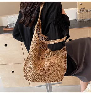 Detail of hand-woven hollow straw mesh tote bag with natural wood texture and large mesh pattern