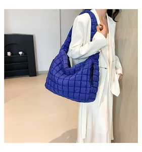Macro detail of royal blue quilted cloud bag showing the soft texture and drawstring