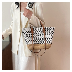 Bohemian handwoven tote bag with black and white texture and brown leather handles