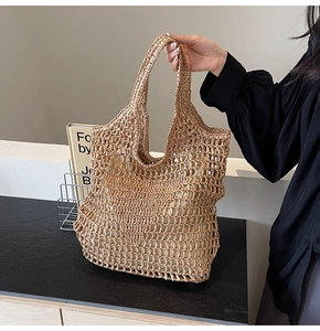 Detail showing the large-hole mesh weave and beige linen lining of the straw tote bag