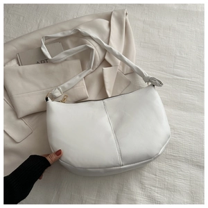 Minimalist white crescent PU leather shoulder bag with gold hardware and knot detail