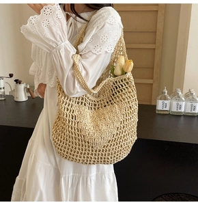 Close-up of beige woven mesh tote bag with handmade cotton rope texture and tulips