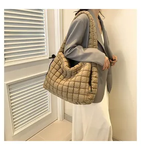 Quilted oversized puffy cloud shoulder bag in khaki shown on model for size perspective