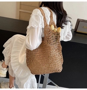 Detail of hand-woven straw tote bag with diamond mesh pattern and hollow out design