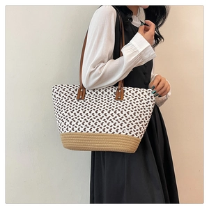Detail of bohemian woven tote bag showing two-tone textures and durable leather straps