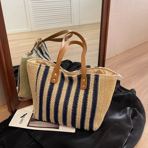 Classic nautical striped straw tote bag with brown leather handles for summer beach vacations