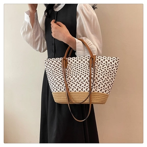 Detail of bohemian handwoven tote bag featuring V-shaped patterns and leather handles