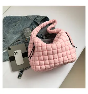 Detailed view of pink quilted puffer tote bag with soft texture and matching thick handle
