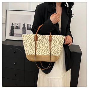 Detailed macro view of bohemian woven tote bag with contrast colors and leather handles