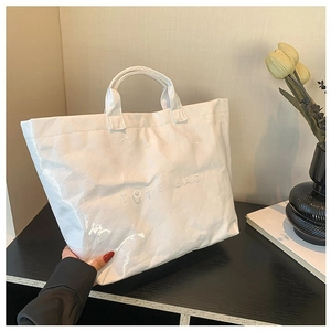 Minimalist white DuPont paper tote bag with TOTE BAG embossing and crinkle texture