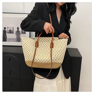 Detail of bohemian woven tote bag with brown leather handles and a long shoulder strap