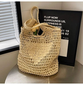 Close-up of handmade beige woven cotton mesh tote bag with floral decor and texture