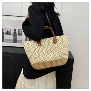 Detailed macro view of contrast woven tote with dual handles and long shoulder strap