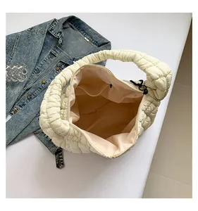 Detail view of large quilted puffer tote bag showing spacious interior and soft texture