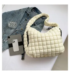 Detail showing the white quilted texture and large capacity of this puffed tote bag