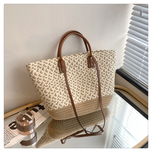 Close-up of handmade woven tote bag with leather handles and fine texture details