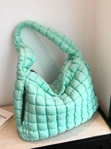 Quilted mint green cloud hobo bag with padded texture and adjustable shoulder strap