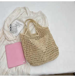 Detailed top-down view of beige woven tote bag with hollow mesh and integrated handles