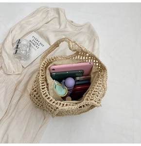Detail view of large capacity beige crochet tote bag showing interior storage space