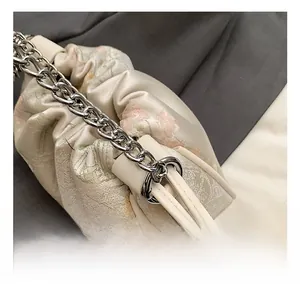 Detail of floral jacquard silk cloud bag with premium silver chunky metal chain