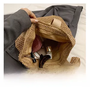 Interior view of the straw tote bag showing ample space for daily essentials and a zipper