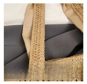 Detailed close-up of khaki woven straw handbag with a wide flat handle and tight weave texture