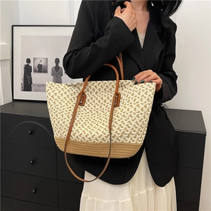 Bohemian handmade woven tote bag with two-tone straw pattern and brown leather handles