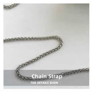 Macro shot of a silver wheat chain strap with polished metal finish and fine textures