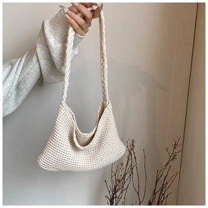 Detail view of the hand-woven texture and soft cotton rope handle of the cream tote bag