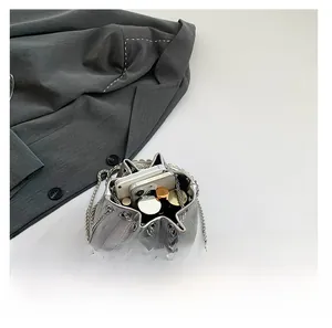 Top view of star-shaped silver crossbody bag showing interior space for phone and lipstick