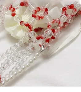 Detailed macro view of trendy beaded lanyard featuring striped and cracked textured beads