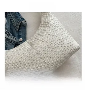 Close-up of white woven PU leather texture and premium stitching on shoulder bag