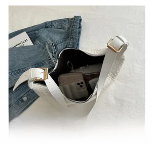 Top view of white woven PU shoulder bag showing spacious interior with daily essentials