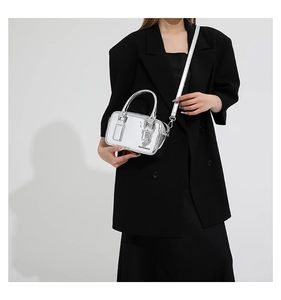 Close-up of metallic silver mini bag with Fashion & Bags print on smooth PU leather