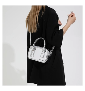 Macro view of silver metallic mirror surface and fashion text on the mini shoulder bag