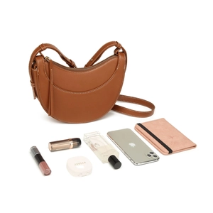 Detail view of brown PU saddle bag showing spacious interior with daily essentials