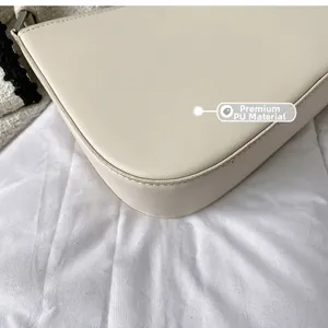 Close-up of premium off-white PU leather texture and stitching on an underarm bag