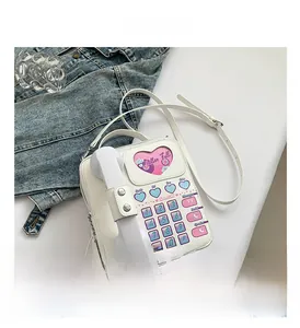 Close-up of white Y2K retro telephone shaped PU leather bag with heart dial detail