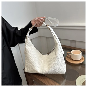 Detail of white woven PU leather hobo bag with gold metal buckle and leather strap